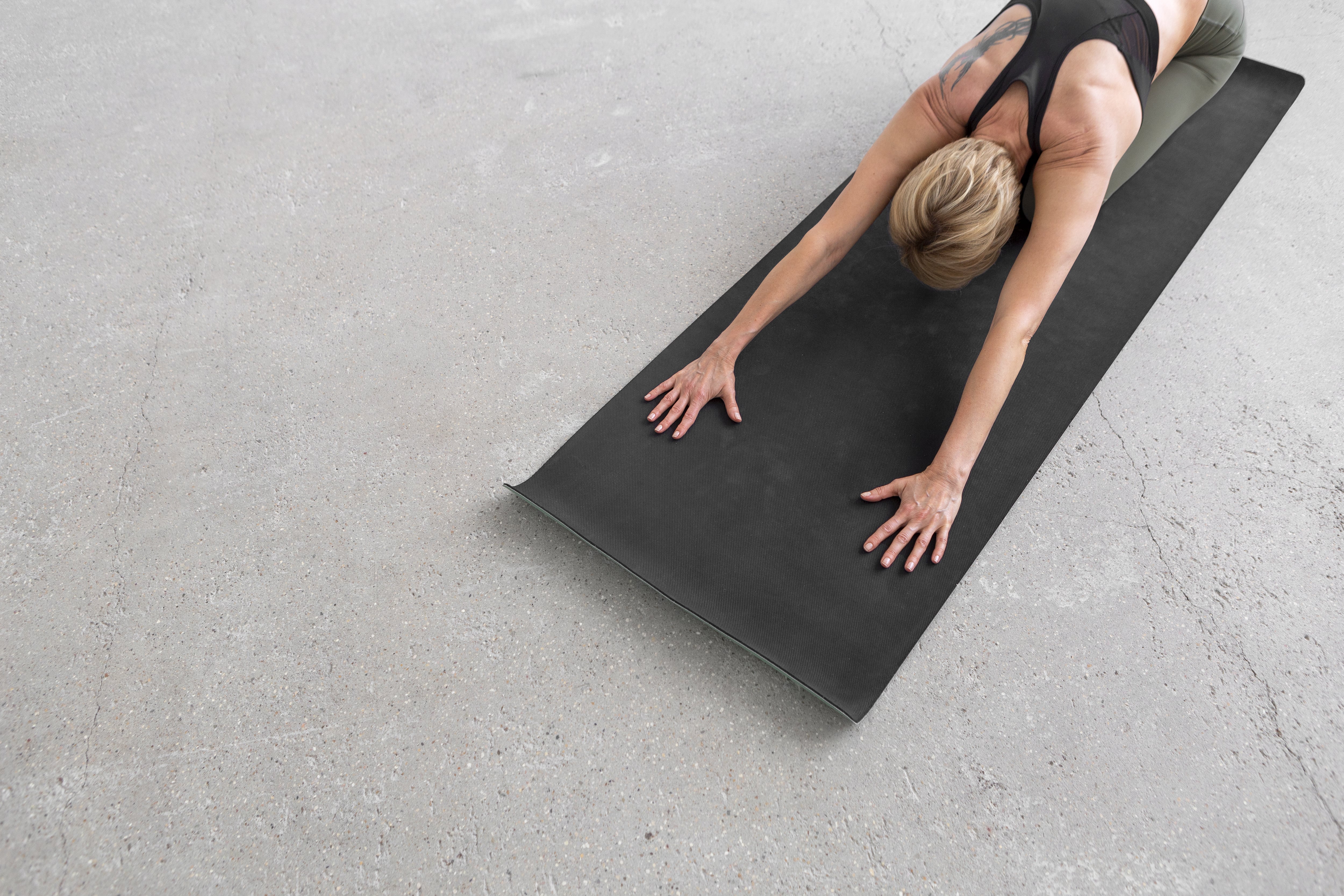  woman-stretching-yoga-mat-min