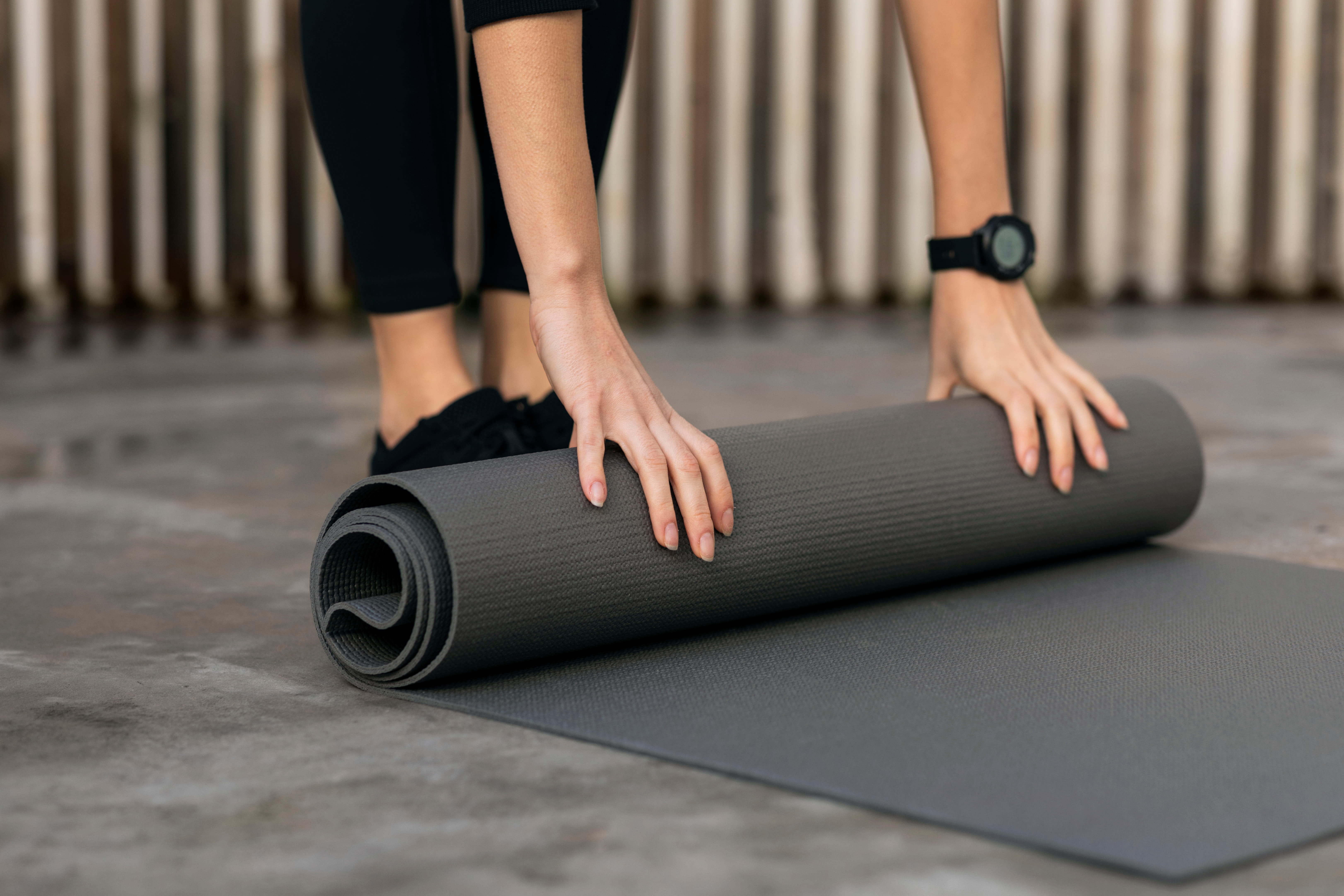  caucasian-millennial-woman-sportswear-with-fitness-tracker-puts-mat-floor-exercising-yoga_1