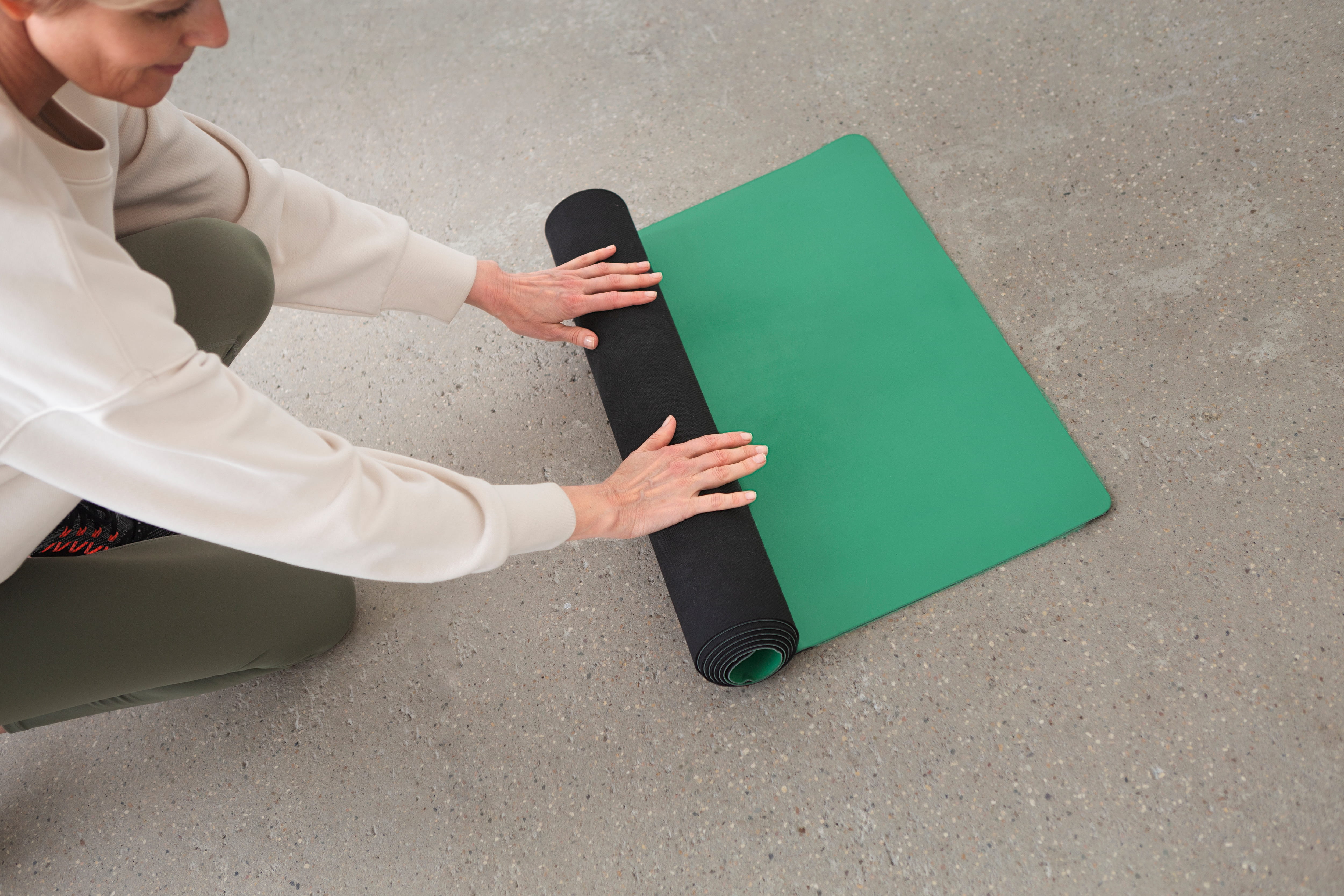  woman-rolling-yoga-mat_1